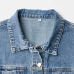 Close up detail of denim jacket with MomLifeTV logo